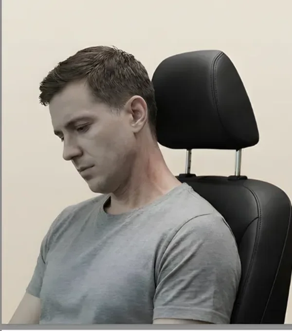 Head slumped against a bare car headrest