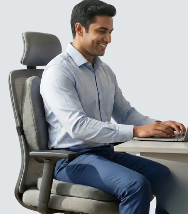 A man sitting upright at a desk with a Kusho cushion