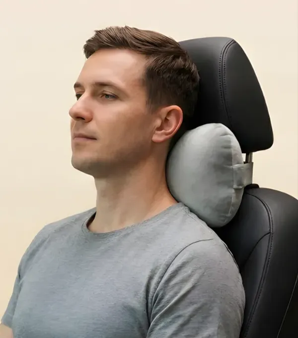 A man resting his neck against a Kusho neck cushion